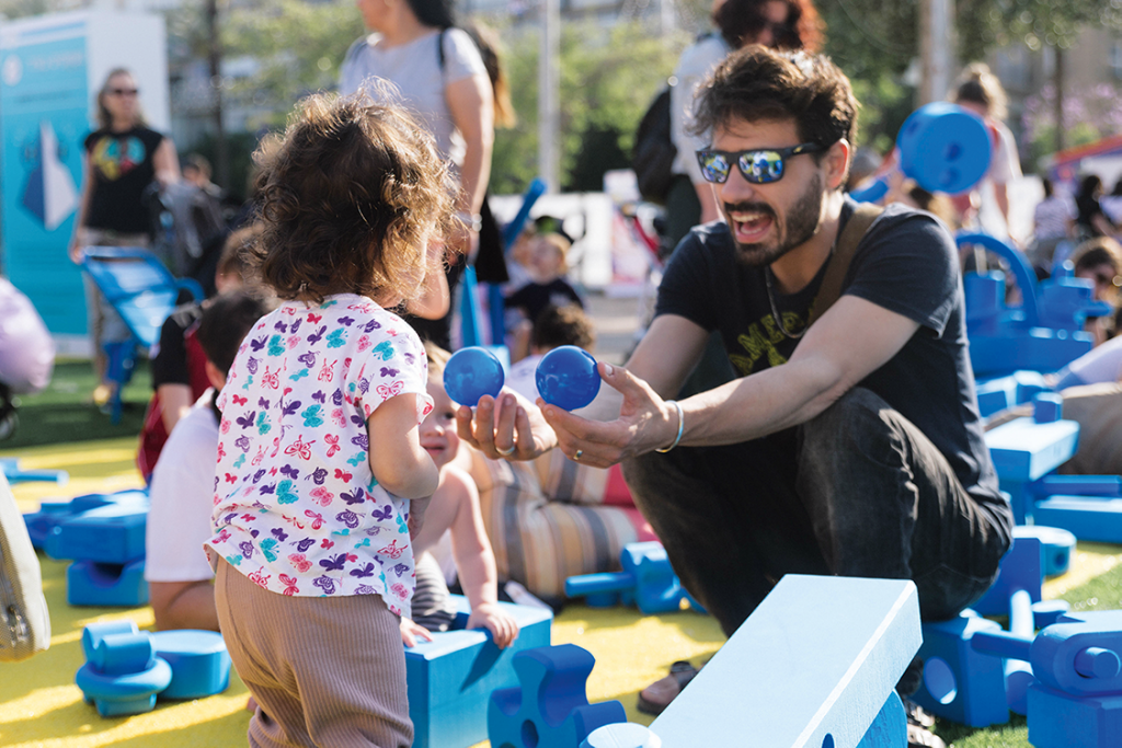 Father playing with child at pop-up play event in Tel Aviv