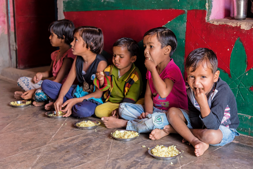 Young children eating fortified porridges