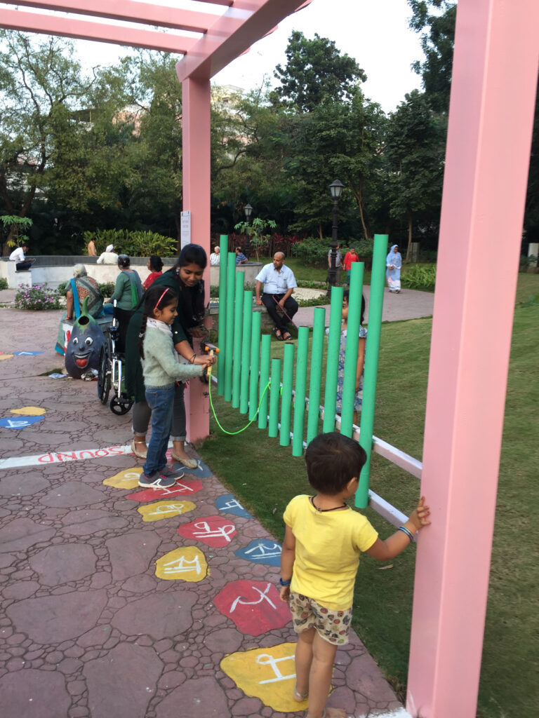 Children playing with a musical instrument with a caregiver